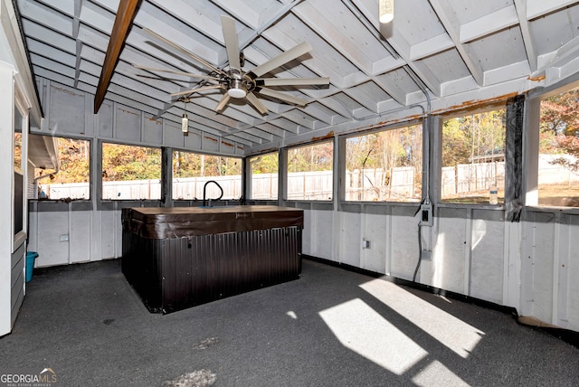 unfurnished sunroom featuring a jacuzzi, a wealth of natural light, lofted ceiling, and ceiling fan