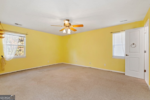 carpeted empty room with ceiling fan