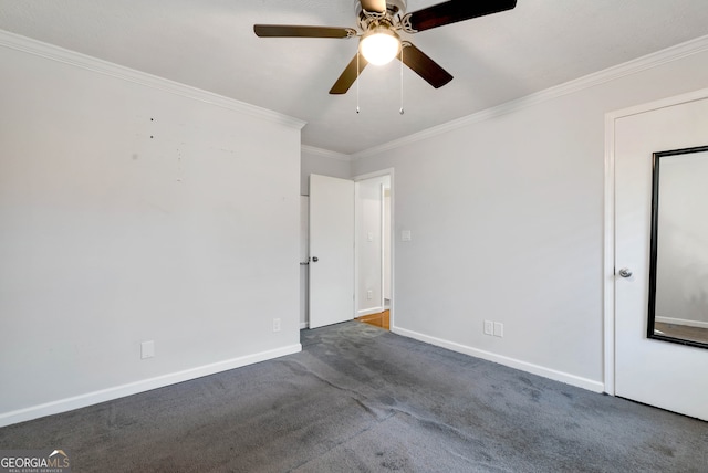 carpeted empty room featuring ceiling fan and crown molding