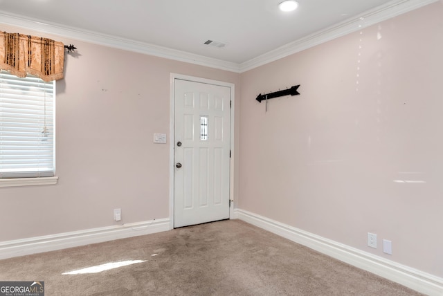 foyer entrance with carpet floors and ornamental molding