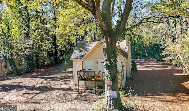 view of side of home featuring a wooden deck