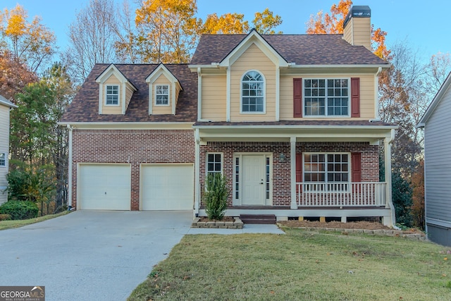 view of front facade featuring a front yard, a garage, and covered porch