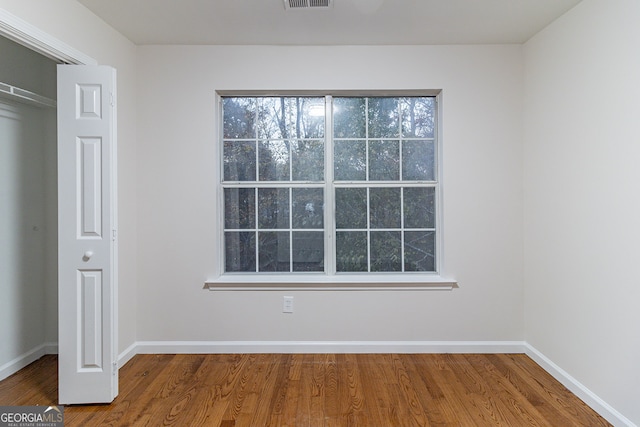 unfurnished bedroom featuring wood-type flooring and a closet