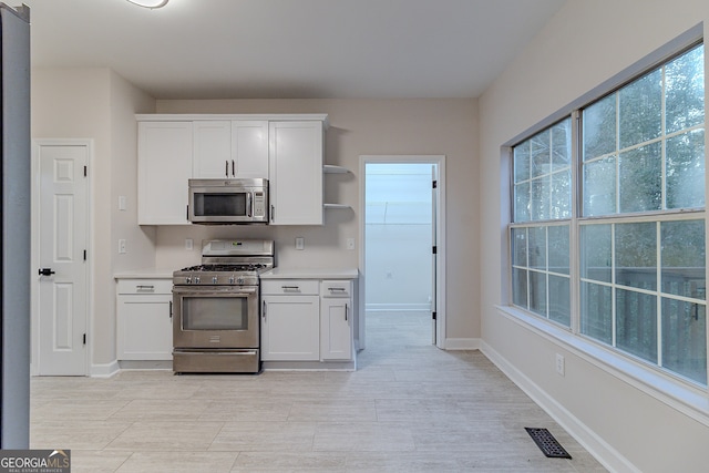 kitchen featuring appliances with stainless steel finishes and white cabinetry