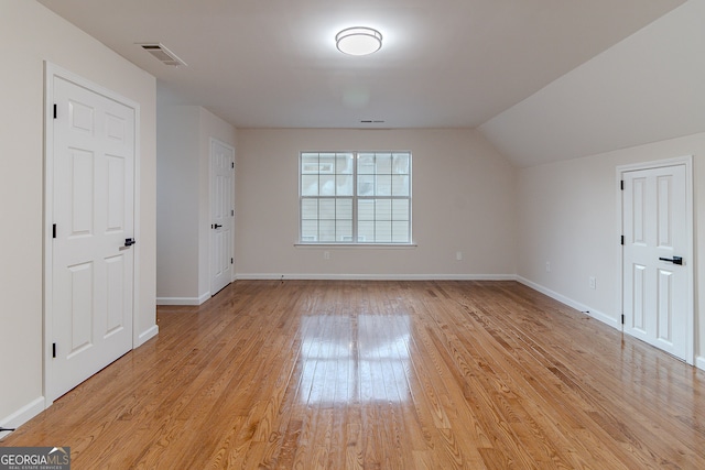 bonus room with light hardwood / wood-style flooring and lofted ceiling