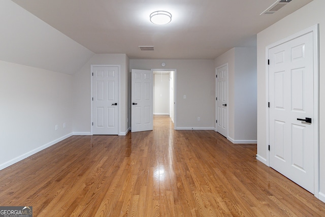 bonus room featuring light hardwood / wood-style flooring and lofted ceiling