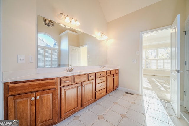 bathroom featuring vanity and lofted ceiling