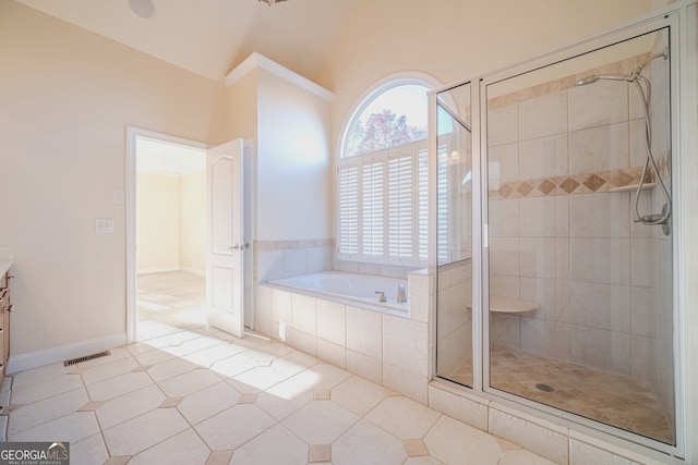 bathroom with tile patterned floors, vanity, and independent shower and bath