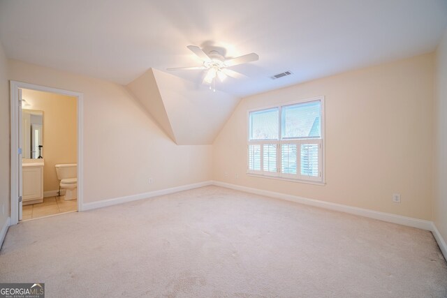 additional living space featuring ceiling fan, light colored carpet, and lofted ceiling