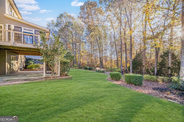 view of yard with a patio area and a wooden deck