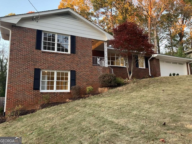 view of side of property with a lawn and a garage