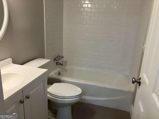 full bathroom featuring tile patterned flooring, vanity, toilet, and tiled shower / bath combo