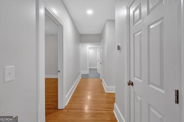 hallway with light hardwood / wood-style flooring