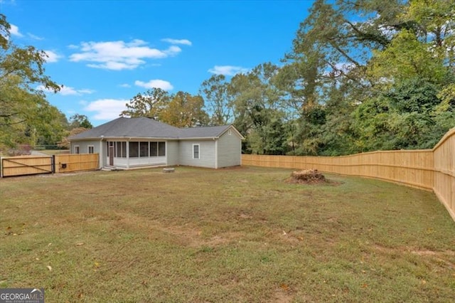 rear view of house with a yard