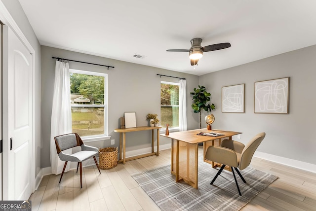 home office featuring ceiling fan, a healthy amount of sunlight, and light hardwood / wood-style flooring