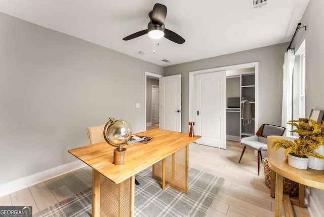 home office featuring light wood-type flooring and ceiling fan