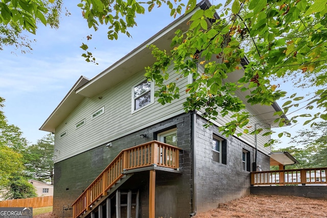 back of house featuring a deck