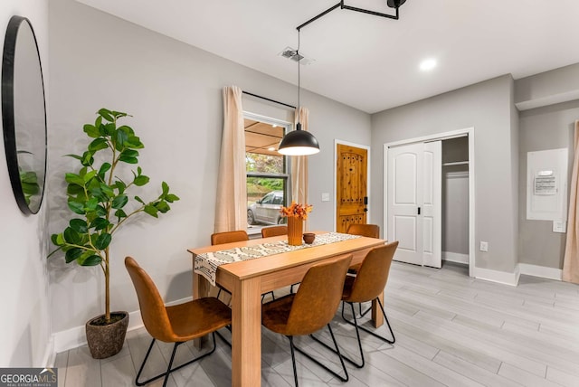 dining space with light hardwood / wood-style floors