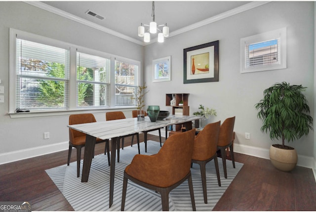 dining area featuring dark hardwood / wood-style floors, an inviting chandelier, and crown molding