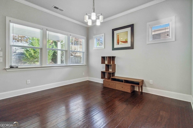 unfurnished room with a chandelier, dark hardwood / wood-style flooring, and crown molding