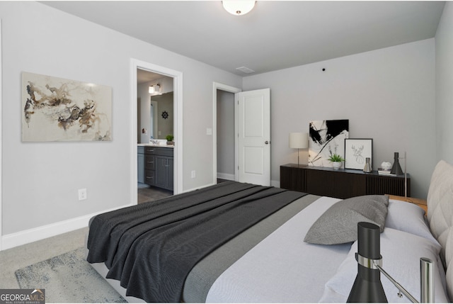 bedroom with carpet floors and ensuite bath