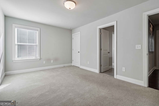 unfurnished bedroom with light colored carpet