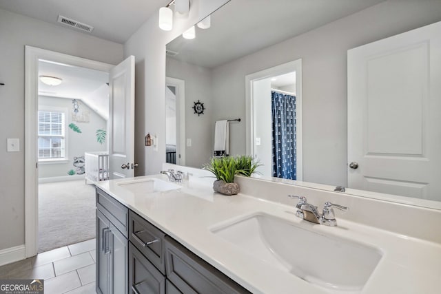 bathroom featuring tile patterned flooring and vanity