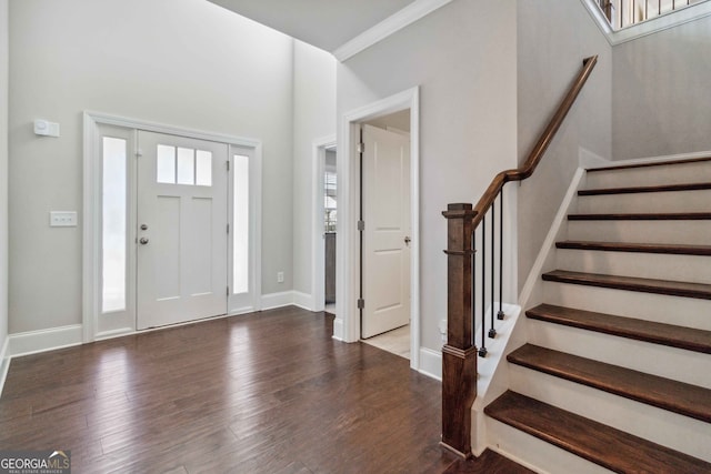 foyer featuring hardwood / wood-style floors and crown molding