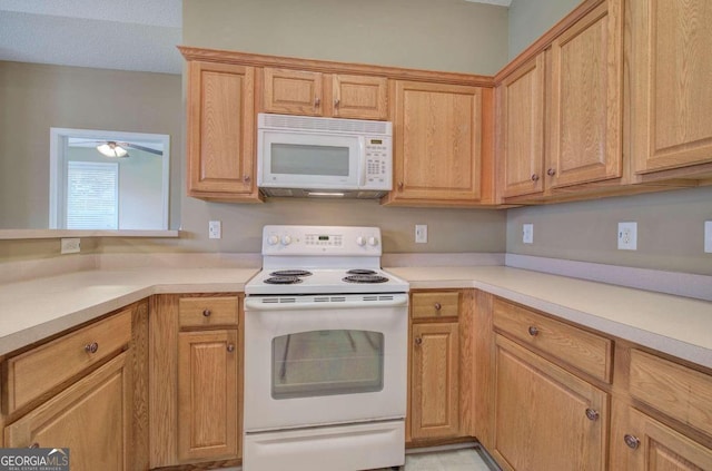 kitchen featuring ceiling fan and white appliances