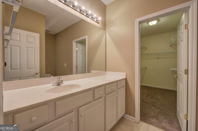 bathroom featuring vanity and a textured ceiling