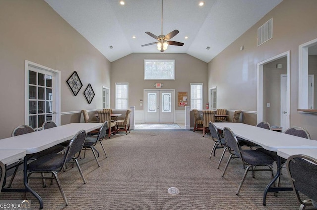 dining room with light carpet, high vaulted ceiling, and ceiling fan