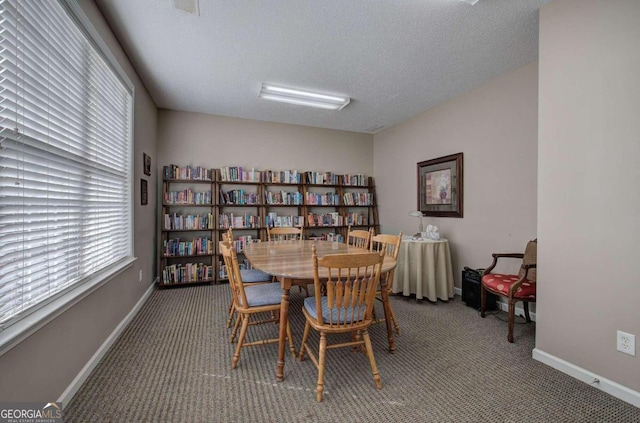 dining area with carpet flooring and a textured ceiling