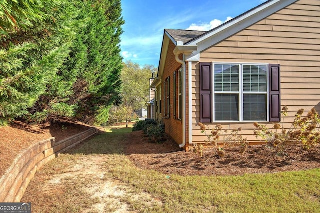 view of side of property with a lawn