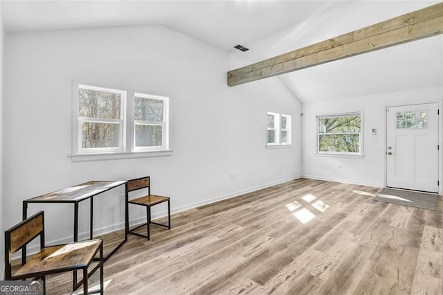 interior space with lofted ceiling with beams and light wood-type flooring