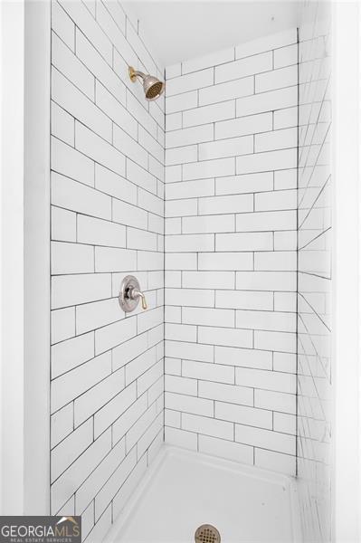 bathroom with a tile shower