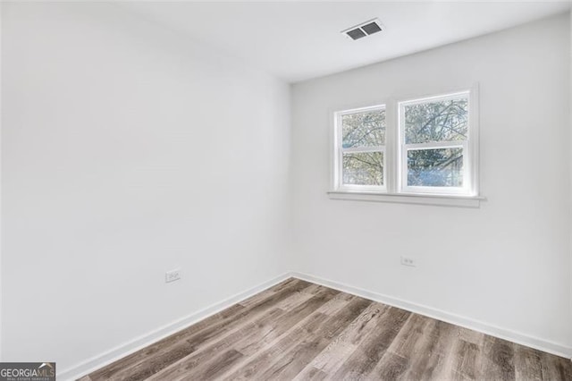 unfurnished room featuring hardwood / wood-style floors