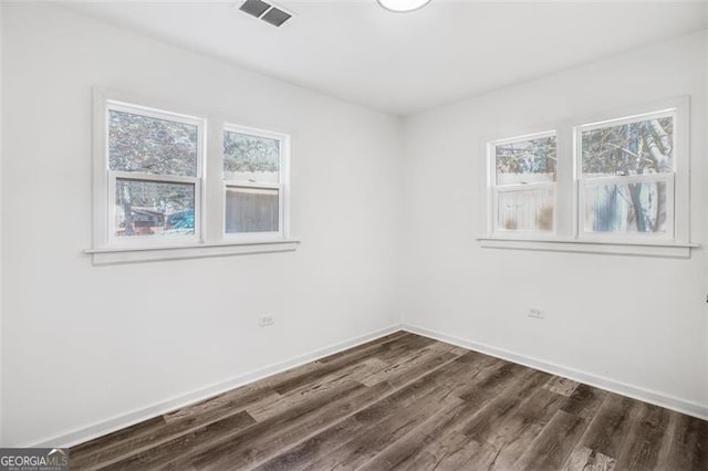 spare room with dark wood-type flooring