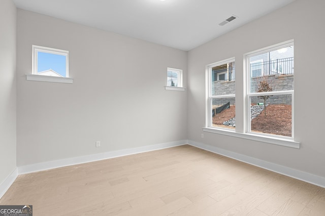 spare room featuring light hardwood / wood-style flooring