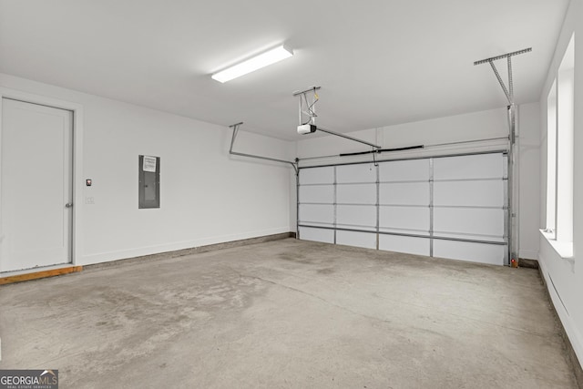 garage with a garage door opener and electric panel