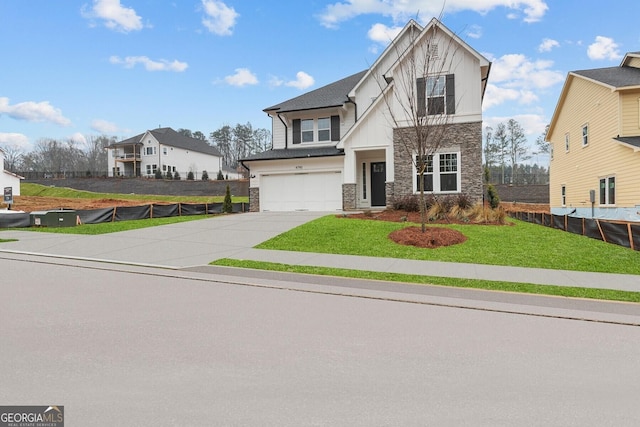 view of front facade featuring a garage and a front yard