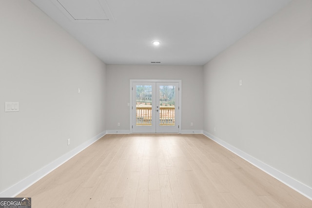 unfurnished room featuring light hardwood / wood-style flooring and french doors