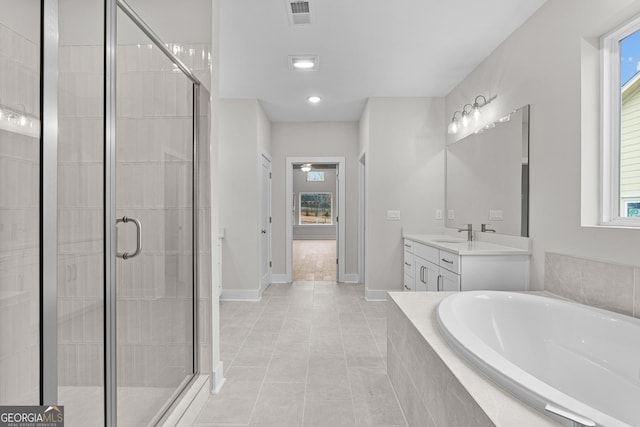 bathroom with tile patterned flooring, vanity, and separate shower and tub