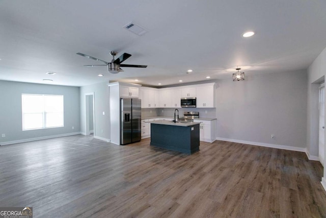 kitchen featuring white cabinetry, hardwood / wood-style floors, and stainless steel appliances