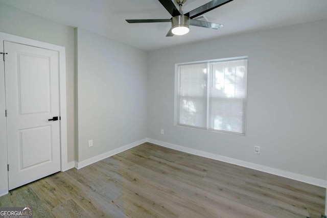 unfurnished room with light hardwood / wood-style floors and ceiling fan