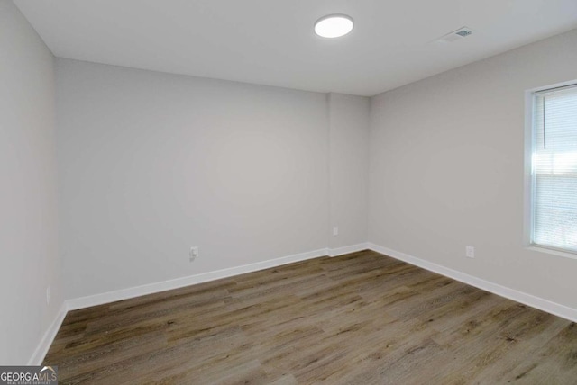 spare room with dark hardwood / wood-style flooring