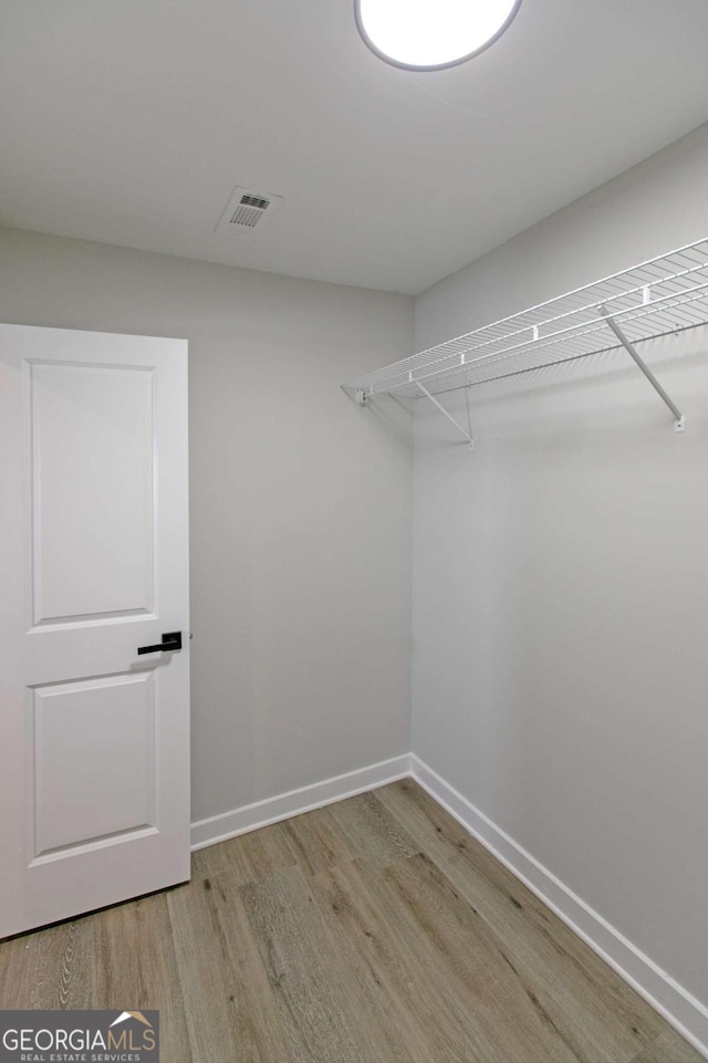 walk in closet featuring light hardwood / wood-style flooring