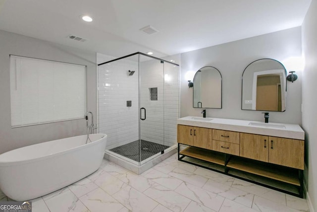 bathroom with vanity and independent shower and bath