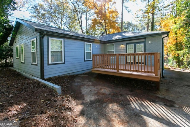 rear view of house featuring a deck