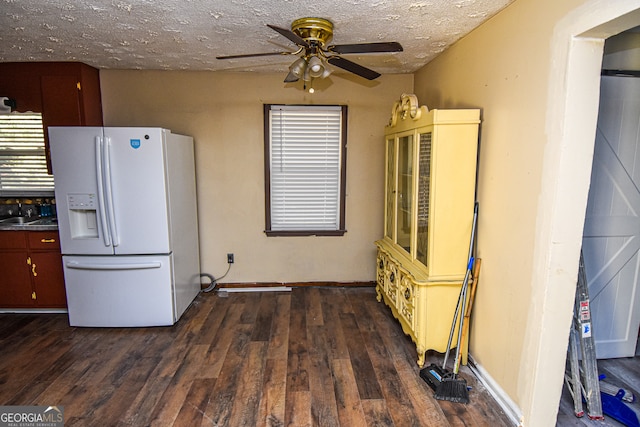 kitchen with white refrigerator with ice dispenser, sink, dark hardwood / wood-style floors, ceiling fan, and a textured ceiling