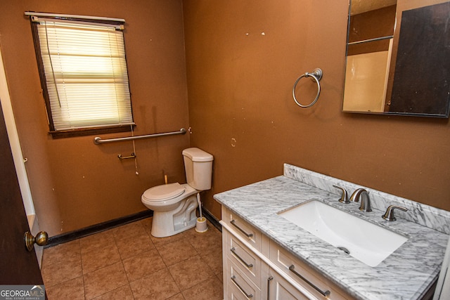 bathroom featuring tile patterned flooring, vanity, toilet, and a shower